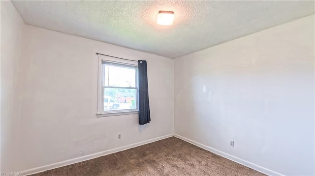2914 Phillips Ave, Greensboro, NC 27405 - empty room featuring a textured ceiling and dark colored carpet