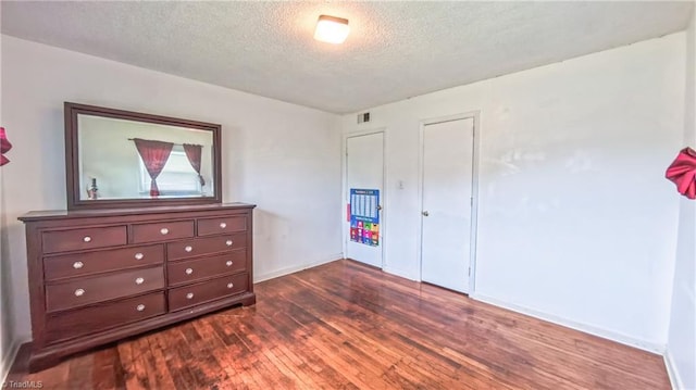 2914 Phillips Ave, Greensboro, NC 27405 - bedroom with dark wood-style floors and a textured ceiling