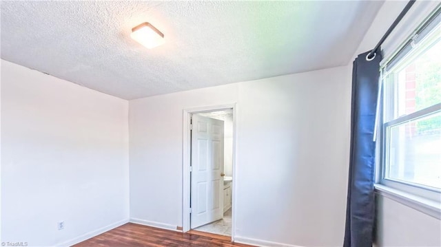 2914 Phillips Ave, Greensboro, NC 27405 - unfurnished room featuring a textured ceiling and wood finished floors