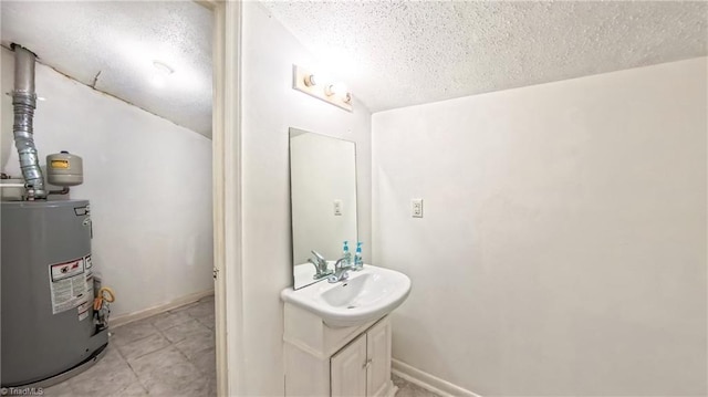 2914 Phillips Ave, Greensboro, NC 27405 - bathroom with water heater, a textured ceiling, and vanity