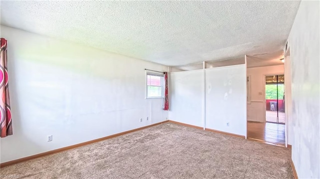 2914 Phillips Ave, Greensboro, NC 27405 - carpeted spare room with a textured ceiling and baseboards