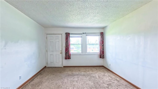 2914 Phillips Ave, Greensboro, NC 27405 - spare room with light carpet and a textured ceiling