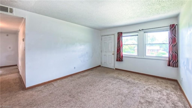 2914 Phillips Ave, Greensboro, NC 27405 - carpeted spare room with a textured ceiling and baseboards
