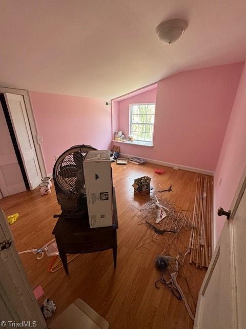 bonus room with vaulted ceiling and wood finished floors