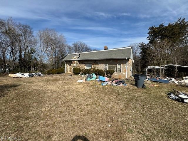 rear view of house with stone siding