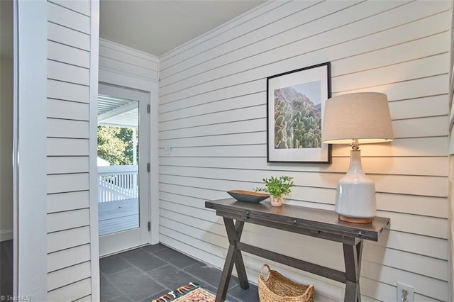 523 N Main St, Graham, NC 27253 - doorway to outside featuring wood walls, dark tile patterned flooring, and crown molding