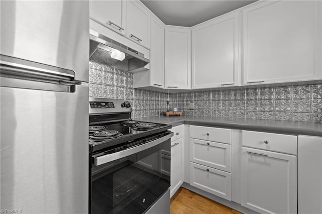 kitchen with light wood-style flooring, appliances with stainless steel finishes, under cabinet range hood, white cabinetry, and backsplash