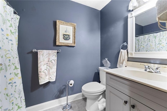 full bathroom with curtained shower, toilet, vanity, baseboards, and tile patterned floors