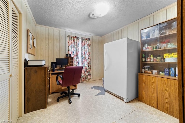 office space with a textured ceiling and ornamental molding