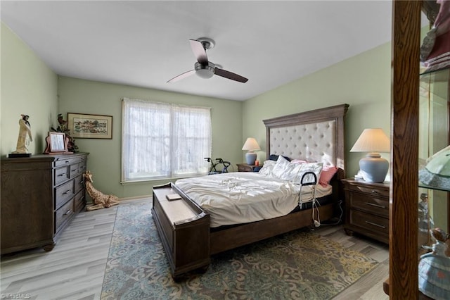 bedroom with light wood-style flooring and ceiling fan