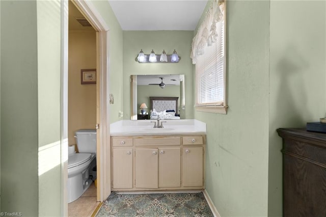 ensuite bathroom featuring visible vents, connected bathroom, toilet, tile patterned floors, and vanity