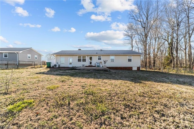 rear view of house featuring a patio, a lawn, and a fenced backyard