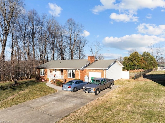 ranch-style house with brick siding, a chimney, a porch, driveway, and a front lawn