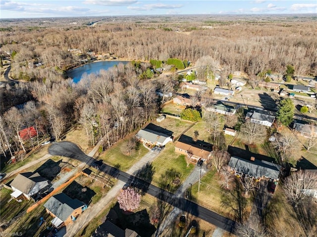 drone / aerial view featuring a water view and a wooded view