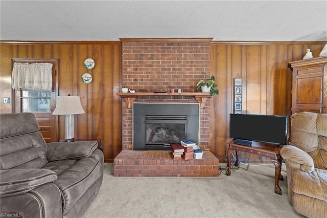 living area featuring carpet, wood walls, a fireplace, and a textured ceiling