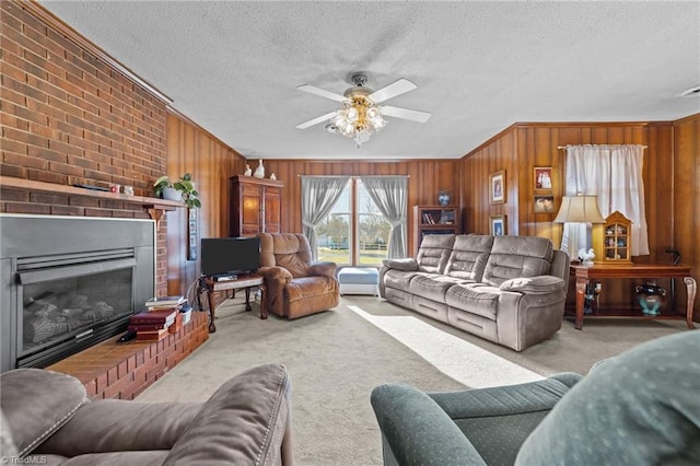 living area with a textured ceiling, a fireplace, carpet flooring, and wooden walls