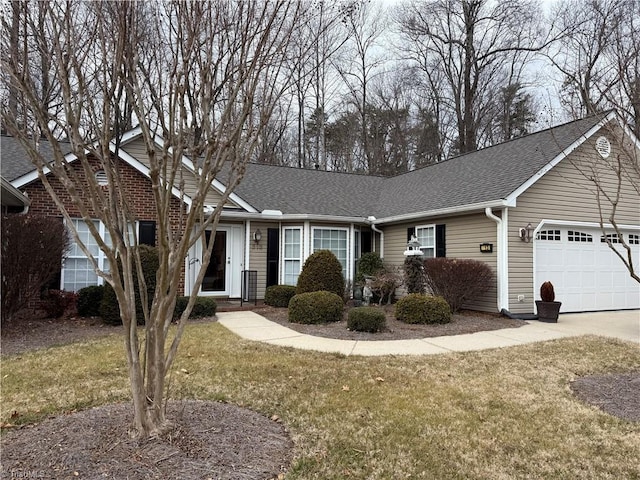 ranch-style house featuring a garage and a front lawn