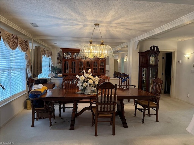 dining area with crown molding, light colored carpet, an inviting chandelier, and a textured ceiling