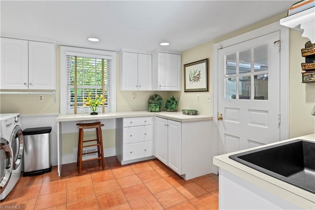 clothes washing area featuring cabinet space, light tile patterned flooring, separate washer and dryer, and recessed lighting
