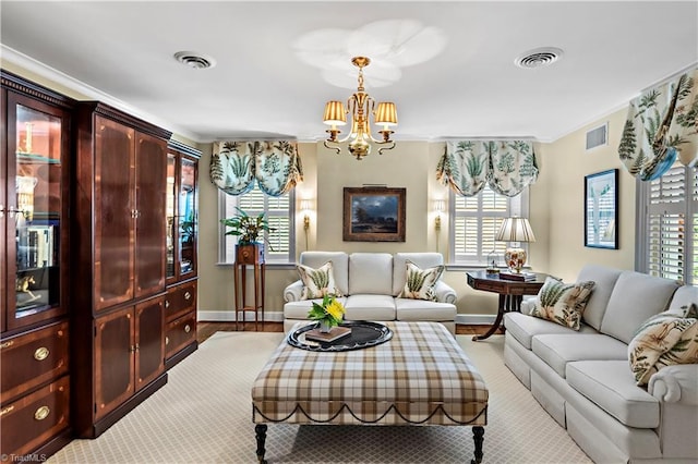 living room with a chandelier, baseboards, and ornamental molding