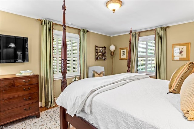 bedroom with light wood-style floors and crown molding