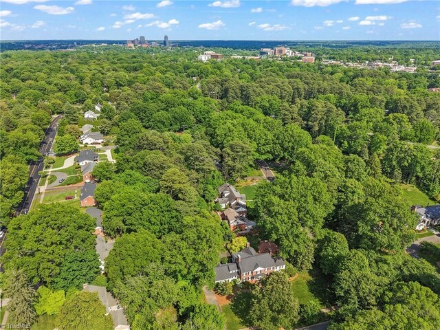 view of property location with a heavily wooded area