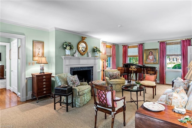 living room with crown molding, a premium fireplace, wood finished floors, and baseboards