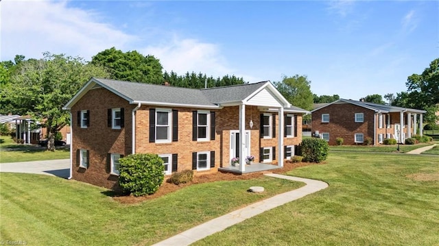 view of front of home featuring a front lawn and brick siding