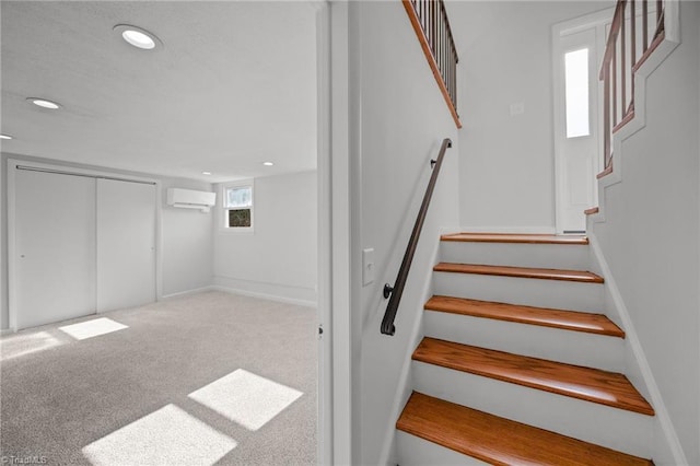 stairs featuring carpet floors, a wall mounted AC, baseboards, and recessed lighting
