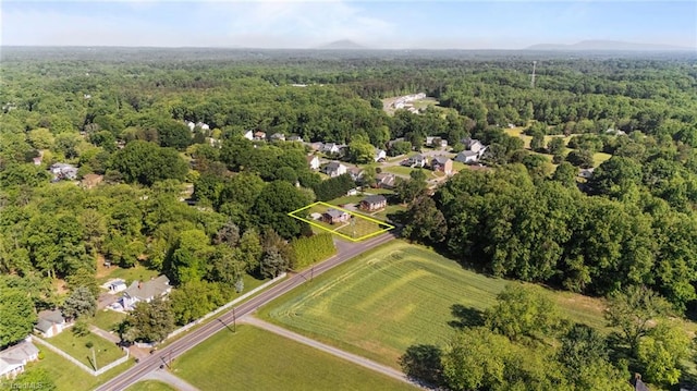 birds eye view of property featuring a forest view