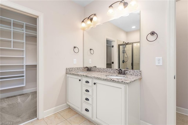 2403 Hammock Dr, High Point, NC 27265 - full bathroom featuring double vanity, a shower stall, tile patterned flooring, and a spacious closet
