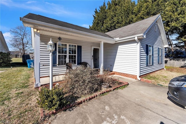 ranch-style house with a front lawn and a porch