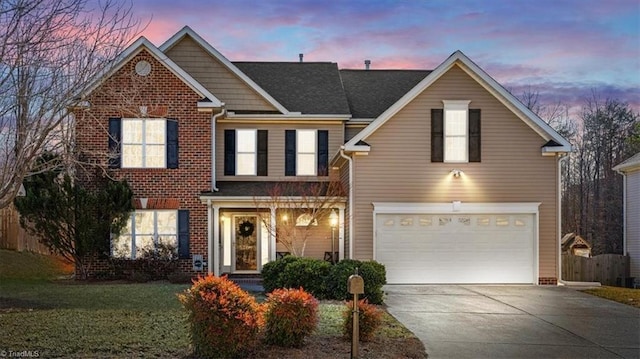 front of property featuring a garage and a yard