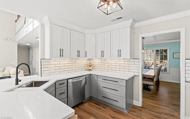 kitchen featuring sink, ornamental molding, stainless steel dishwasher, and gray cabinets