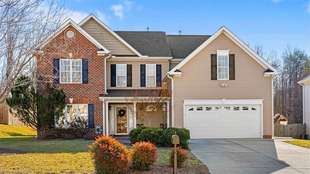 front of property featuring a front lawn and a garage