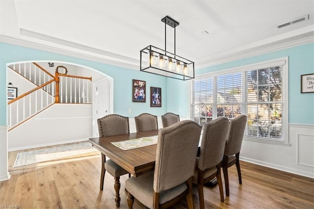 dining area with hardwood / wood-style flooring and a notable chandelier