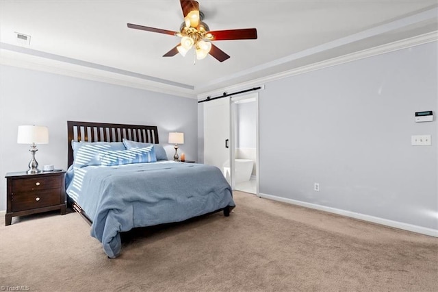 carpeted bedroom with ensuite bath, ceiling fan, a barn door, and ornamental molding