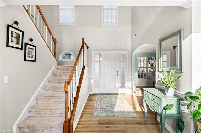 entryway with a high ceiling and hardwood / wood-style floors