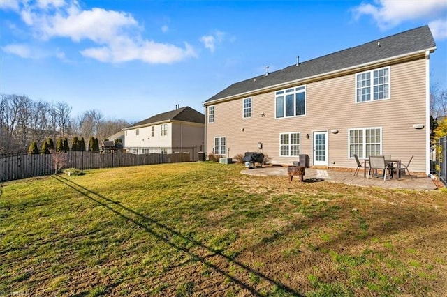 back of property with a patio and a lawn