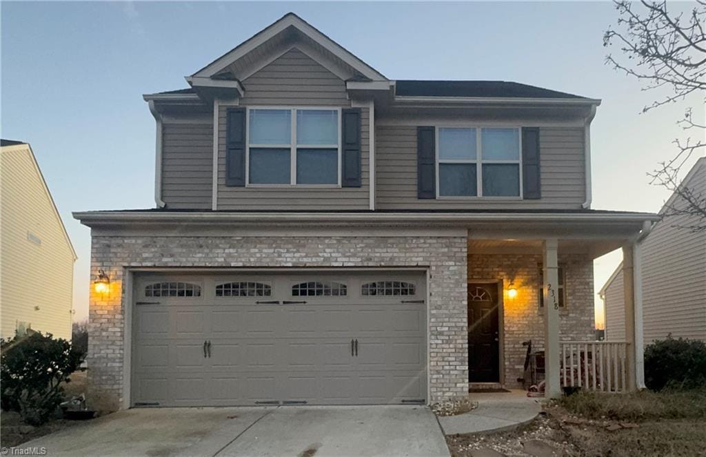 view of front of house featuring a porch and a garage