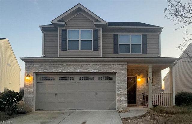 view of front of home with a garage and a porch