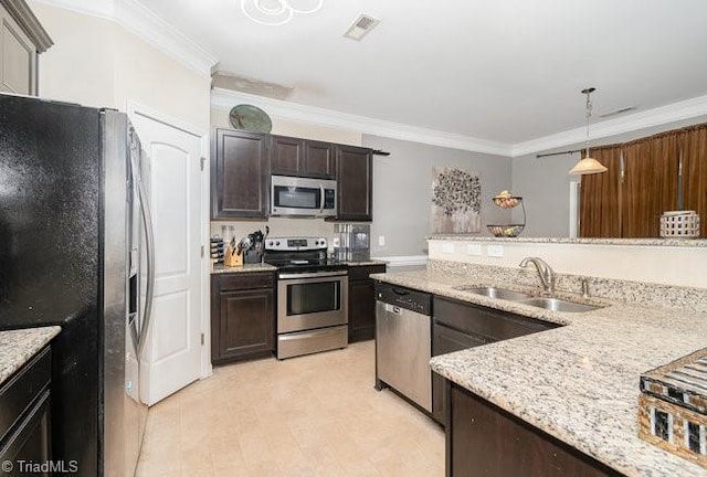 kitchen with sink, crown molding, hanging light fixtures, stainless steel appliances, and dark brown cabinetry