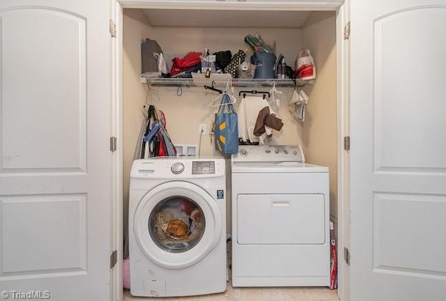 clothes washing area featuring separate washer and dryer