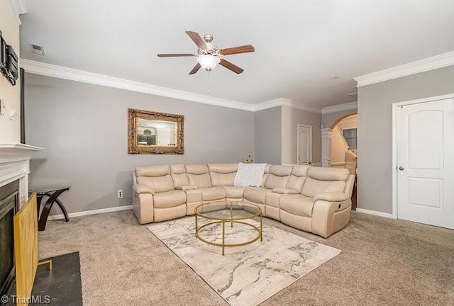 carpeted living room featuring ornamental molding and ceiling fan