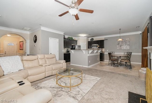 living room with ornamental molding and ceiling fan