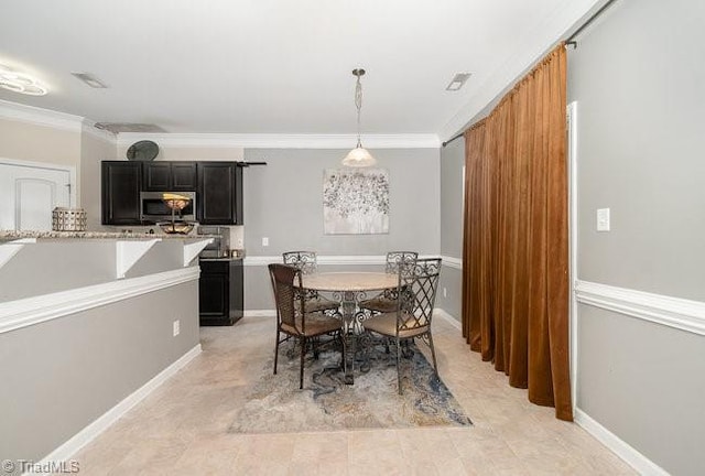 dining space with ornamental molding