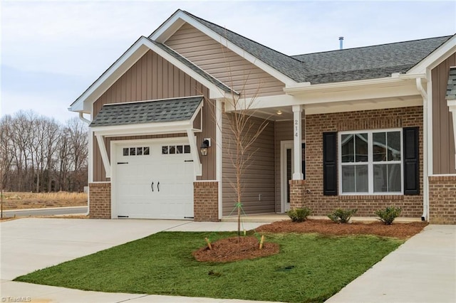 206 Cason Dr, Gibsonville, NC 27249 - craftsman-style home featuring brick siding, a garage, concrete driveway, and a front lawn