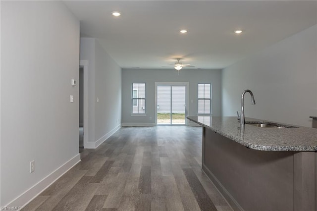 206 Cason Dr, Gibsonville, NC 27249 - kitchen featuring a sink, ceiling fan, dark wood-style floors, an island with sink, and light stone countertops