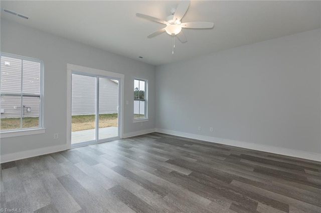 206 Cason Dr, Gibsonville, NC 27249 - spare room with dark wood-style flooring, plenty of natural light, a ceiling fan, and baseboards