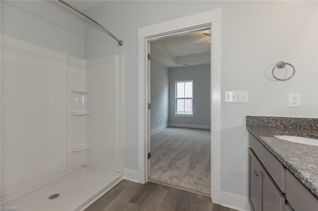 206 Cason Dr, Gibsonville, NC 27249 - bathroom featuring baseboards, a shower, wood finished floors, and vanity
